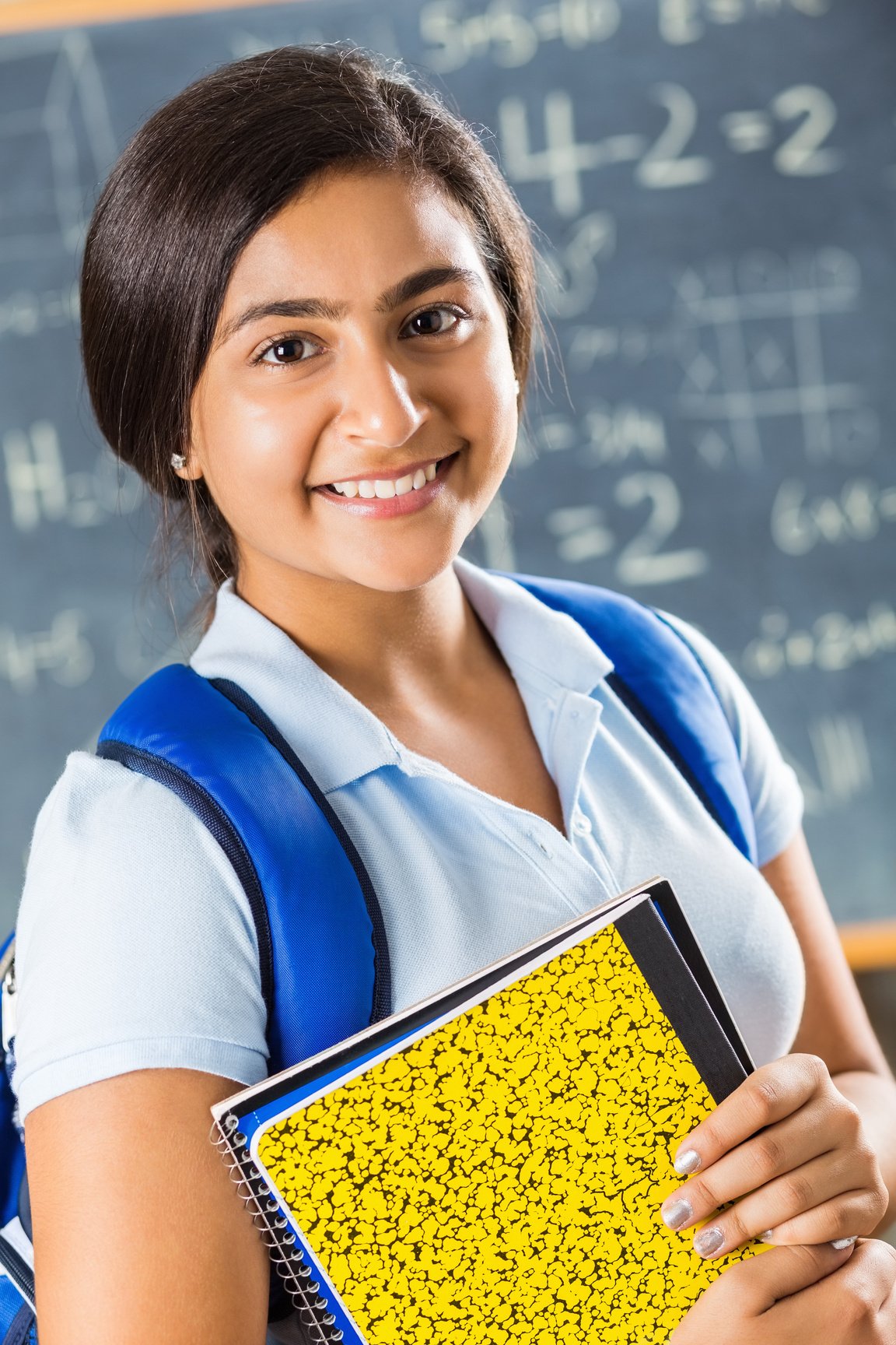 Cute preteen Indian student in math class